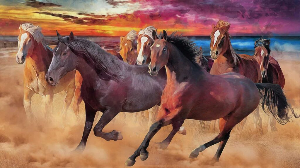 A group of horses gallops across a sandy beach beneath a vivid sunset sky.