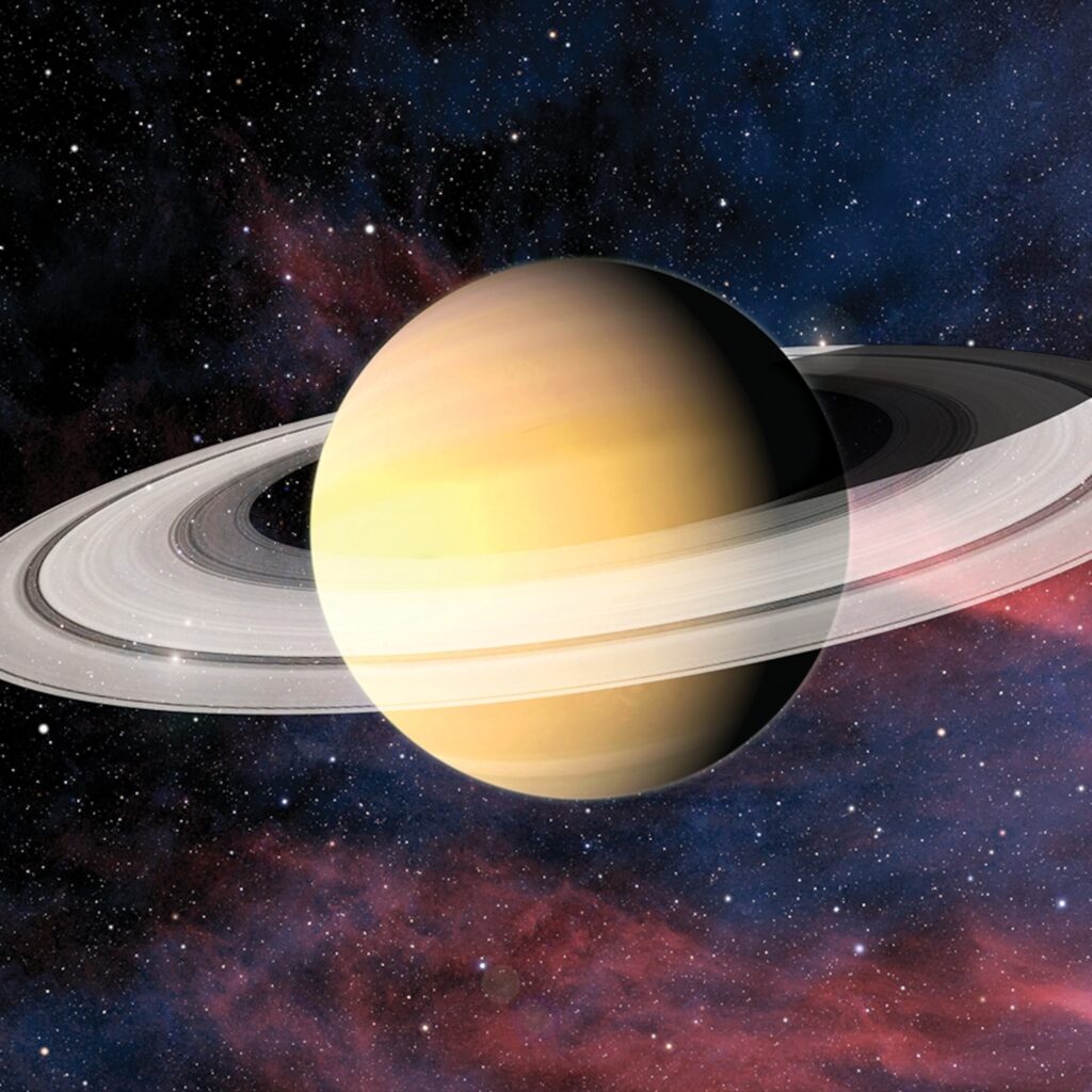 Illustration of golden Saturn with broad rings crossing in front of the planet, set against a colorful star field.